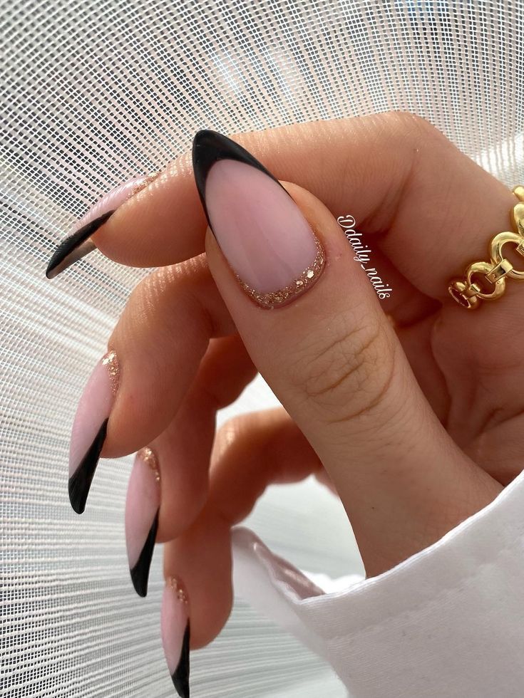 Almond-shaped nails with black French tips, edgy bridal style.