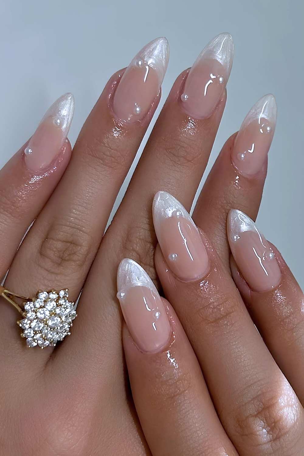 Almond nails with pearlescent tips, elegant bridal style.