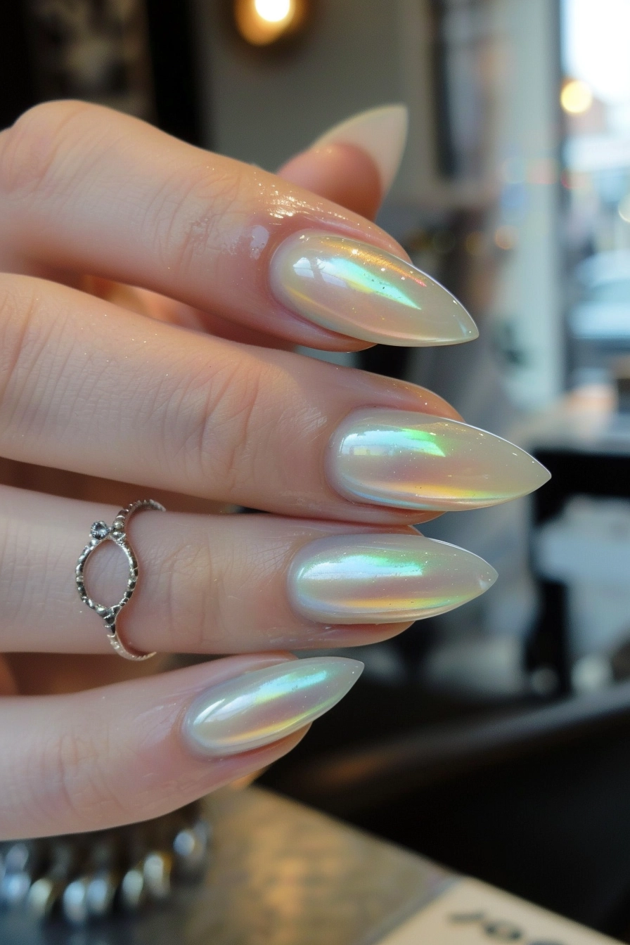 Iridescent pearl nails, shiny stiletto nails.