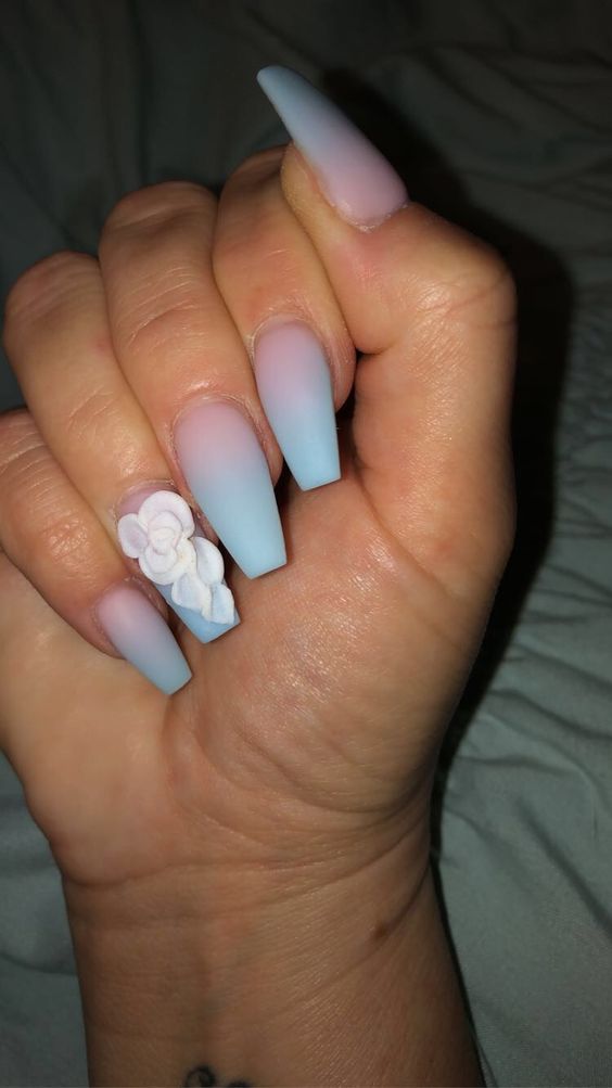 Blue ombre nails with floral 3D accent.